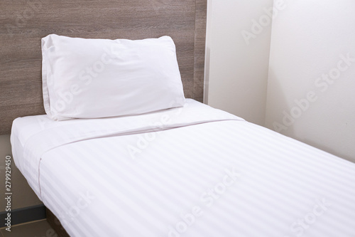 Принти на полотні White single bed and pillow in the bed room close up.