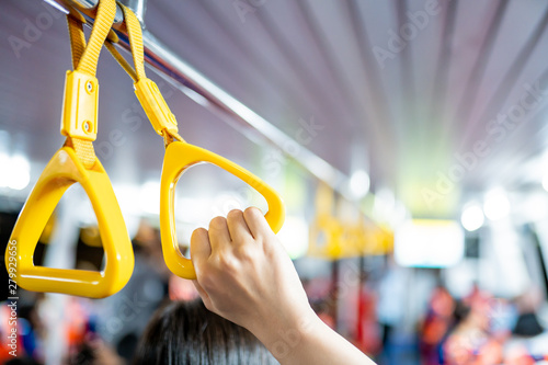 Картината върху платно Safety handgrip in the public transportation ship full with passengers in the ship