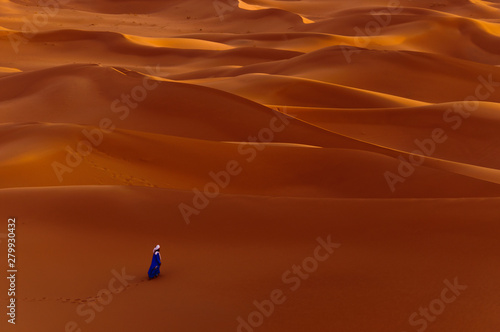 Aerial view of man walking in desert