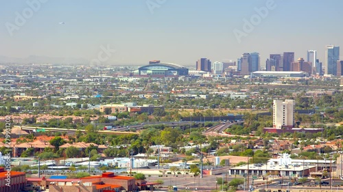 Phoenix AZ City Skyline with Downtown Skyscrapers from a Long Range View Panning Over the Valley Landscape on a Sunny Day in Arizona photo