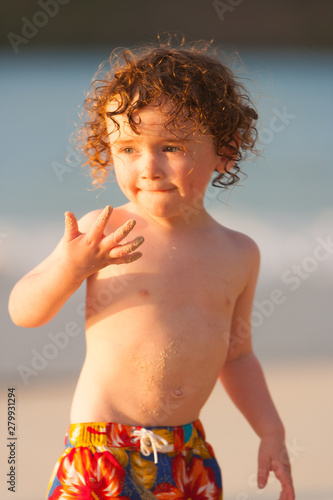 Young boy playing in the surf, Cinnamon Bay, St. John, USVI photo