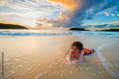 Young boy playing in the surf, Cinnamon Bay, St. John, USVI photo