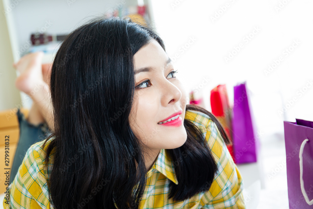 Pretty Asian woman teenager relaxing in living room. Young woman's portrait close up. Pretty Asian woman teenager relaxing in living room. Young woman's portrait close up.