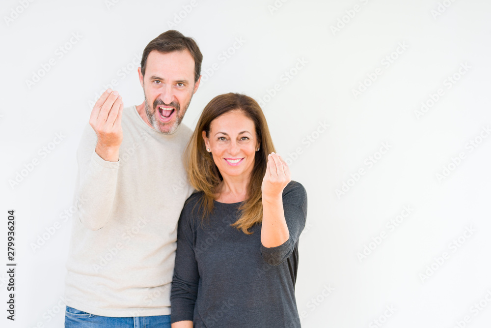 Beautiful middle age couple in love over isolated background Doing Italian gesture with hand and fingers confident expression Beautiful middle age couple in love over isolated background Doing Italian gesture with hand and fingers confident expression