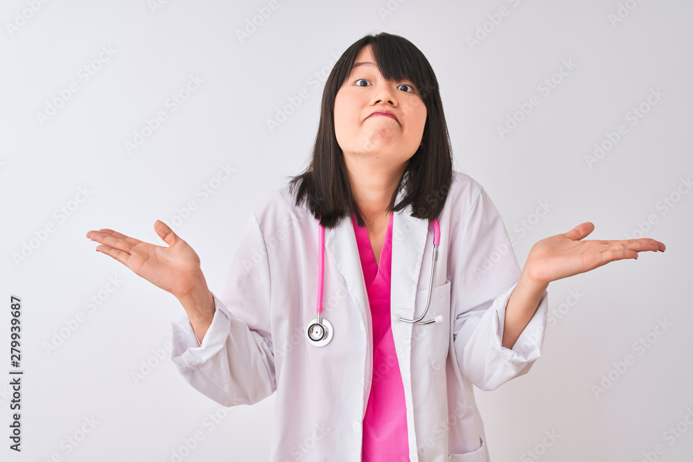 Young beautiful chinese doctor woman wearing stethoscope over isolated white background clueless and confused expression with arms and hands raised. Doubt concept. Young beautiful chinese doctor woman wearing stethoscope over isolated white background clueless and confused expression with arms and hands raised. Doubt concept.