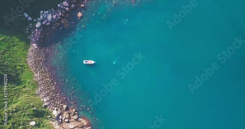 Top down aerial view of vibrant waters of Isla del Arvoredo, slow aerial rise photo