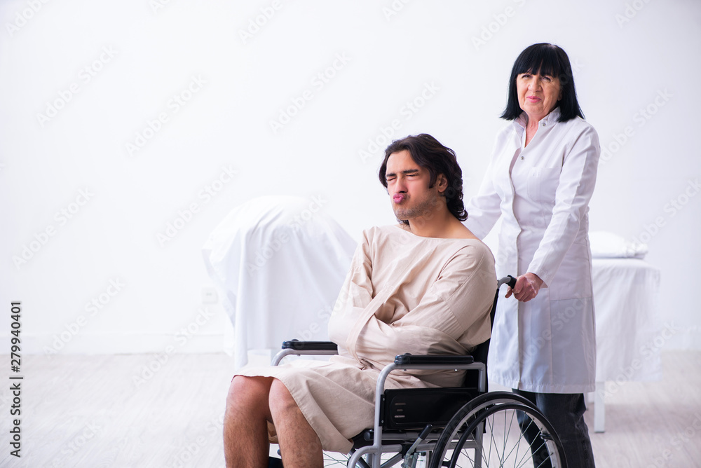 Old female psychiatrist visiting young male patient Old female psychiatrist visiting young male patient