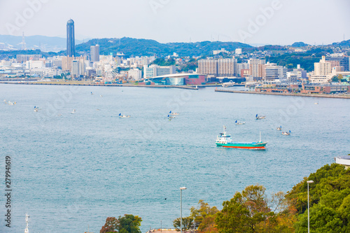 Kitakyushu, Japan - November 20, 2016 :Views of the island of Honshu, Osaka, Japan, a large port city and a commercial center, viewed from Kanmon strait and Kanmonkyo Bridge. photo