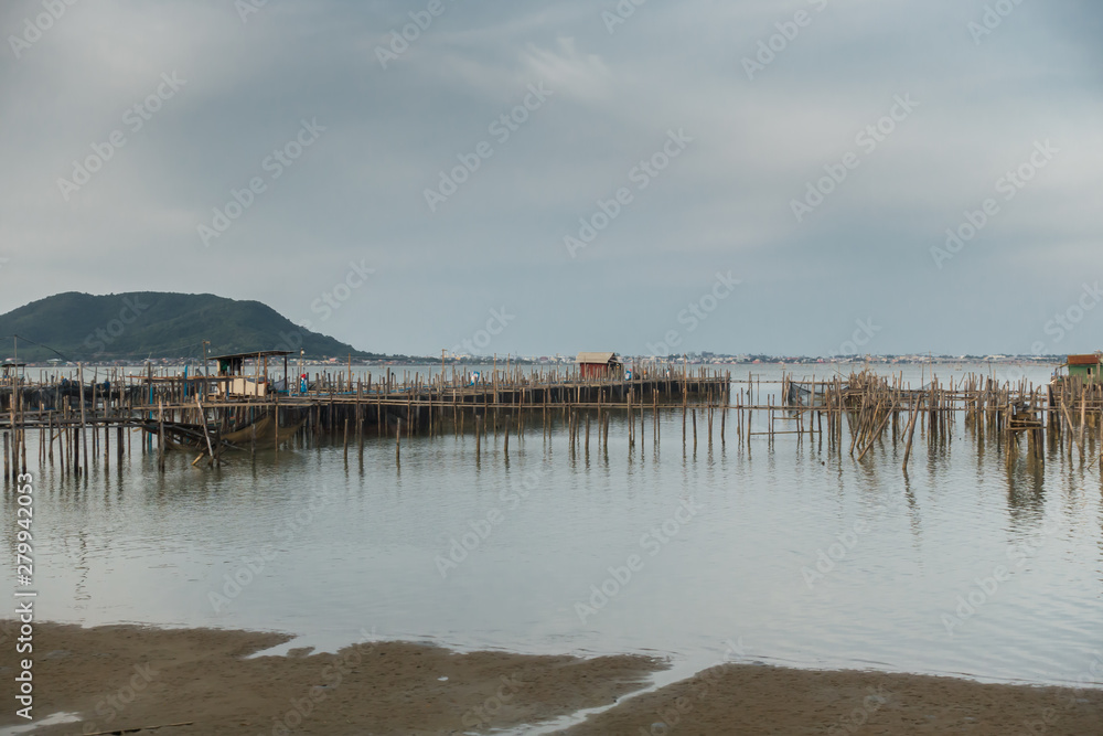 Old wooden bridge in Thai fishing village.