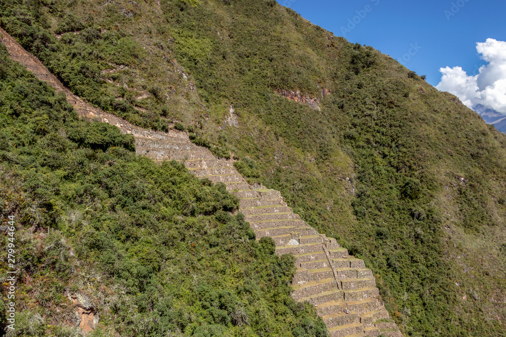 View of the famous llama terraces with white stone llamas in Choquequirao archeological site ruins, Peru View of the famous llama terraces with white stone llamas in Choquequirao archeological site ruins, Peru