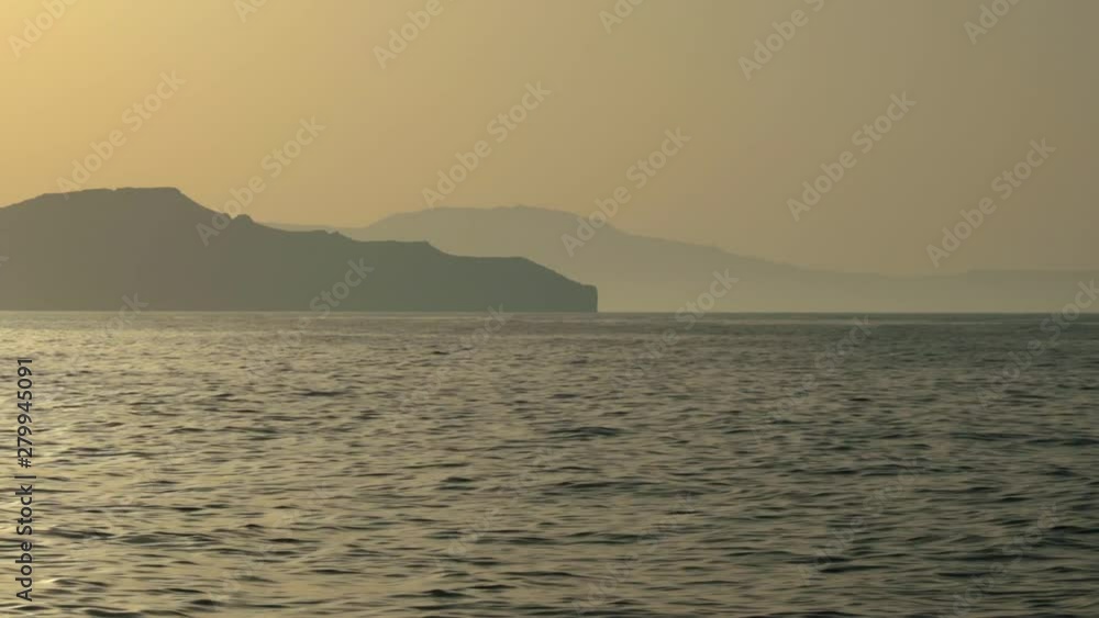 Beautiful sunset with ocean and island in the background. Beautiful sunset with ocean and island in the background.