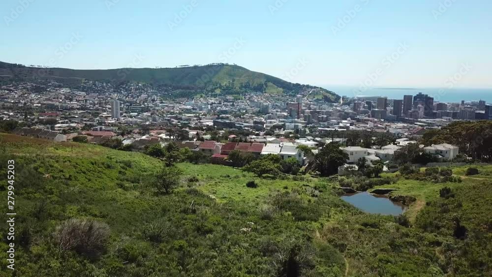 Drone shot of forrest revealing city of Cape Town Drone shot of forrest revealing city of Cape Town