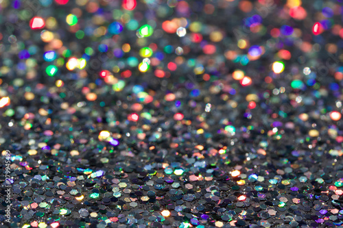 Defocused macro abstract background of sparkling silver glitter texture