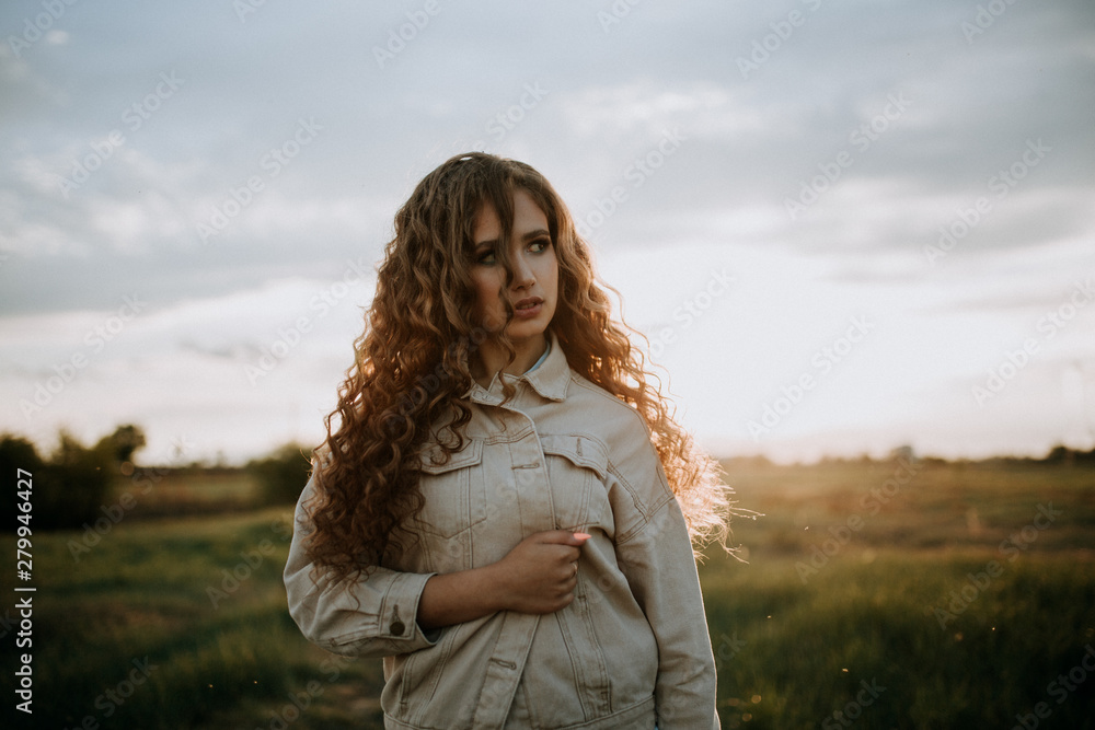 Russian Siberian girl in a field in a summer evening Russian Siberian girl in a field in a summer evening