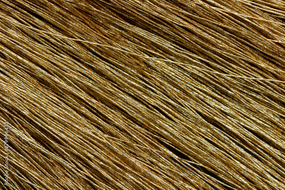 Obraz premium Closeup yellow tassel on table. Concept of fashion article background.