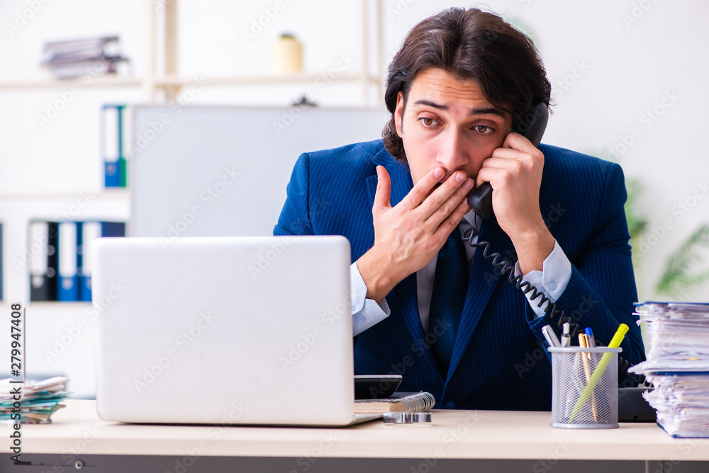 Young businessman sitting and working in the office Young businessman sitting and working in the office