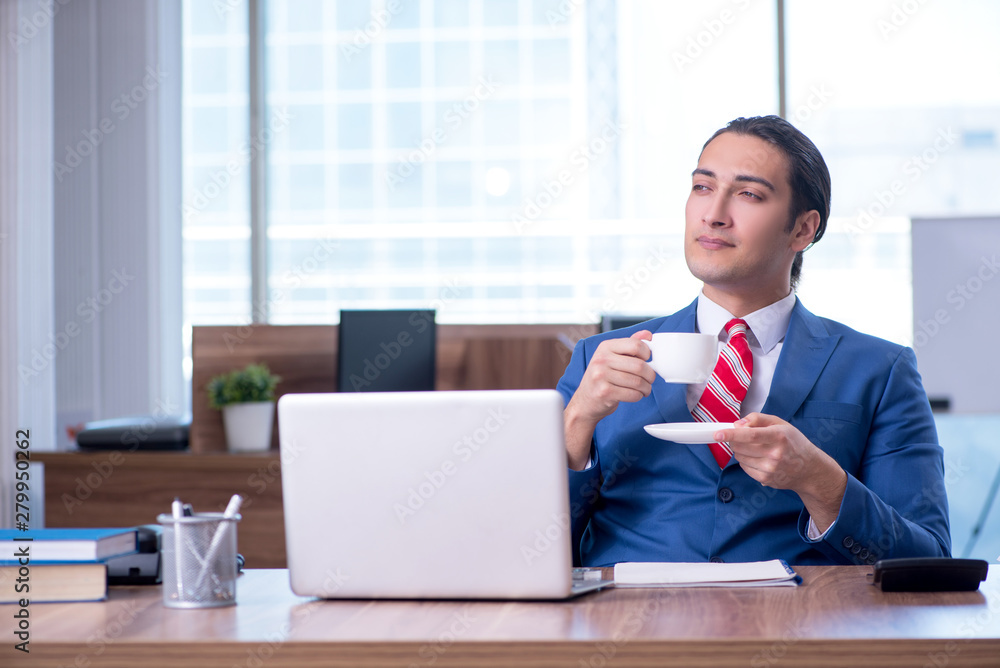 Young handsome businessman sitting in the office Young handsome businessman sitting in the office