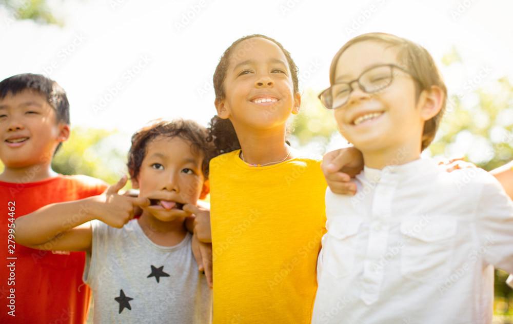 Multi-ethnic group of school kids laughing and embracing Multi-ethnic group of school kids laughing and embracing
