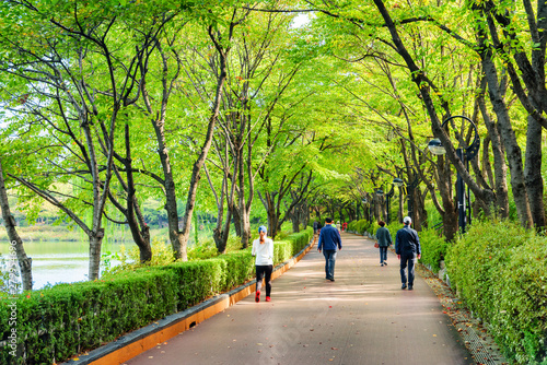 Residents jogging and walking along park in Seoul, South Korea