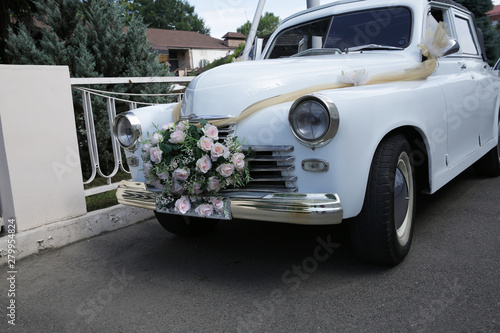 Wedding retro white car decorated with pink flowers. Wedding concept.