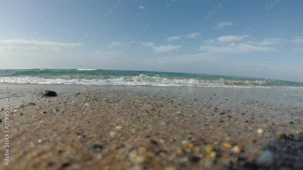 Sandy beach, the coast without people. Sea wave rolled into the shore, slow motion. Sandy beach, the coast without people. Sea wave rolled into the shore, slow motion.