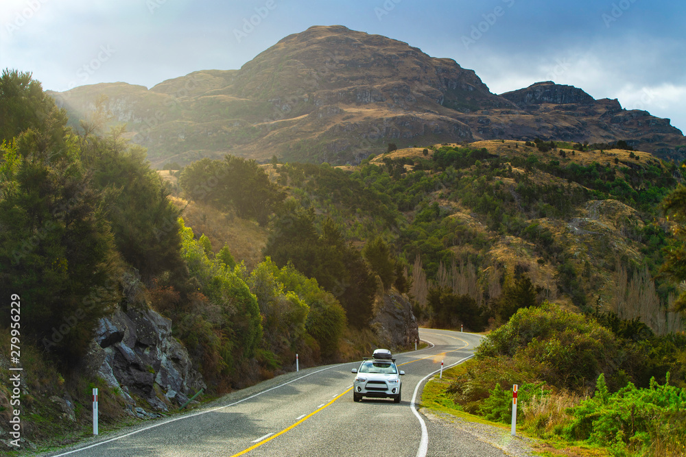 Mountain road and car with beautiful afternoon light in Wanaka, New Zealand