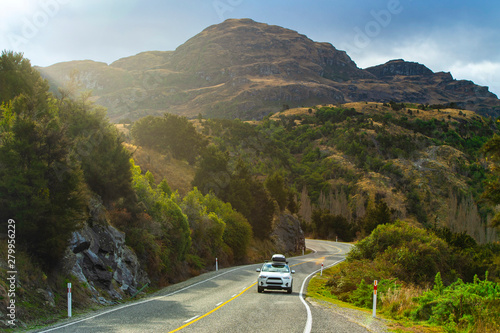 Mountain road and car with beautiful afternoon light in Wanaka, New Zealand