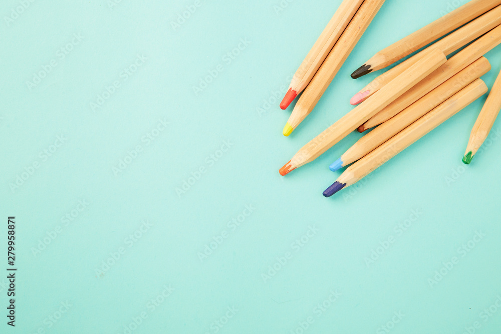 Obraz premium Colorful pencils on pastel pale blue