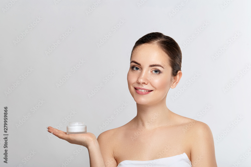 Beauty Face Skin care. Beautiful Woman with healthy smooth facial clean skin holding bottle cosmetic cream. Model with Beauty face. Moisturizer Facial treatment. Cosmetology. Spa. Beauty Face Skin care. Beautiful Woman with healthy smooth facial clean skin holding bottle cosmetic cream. Model with Beauty face. Moisturizer Facial treatment. Cosmetology. Spa.