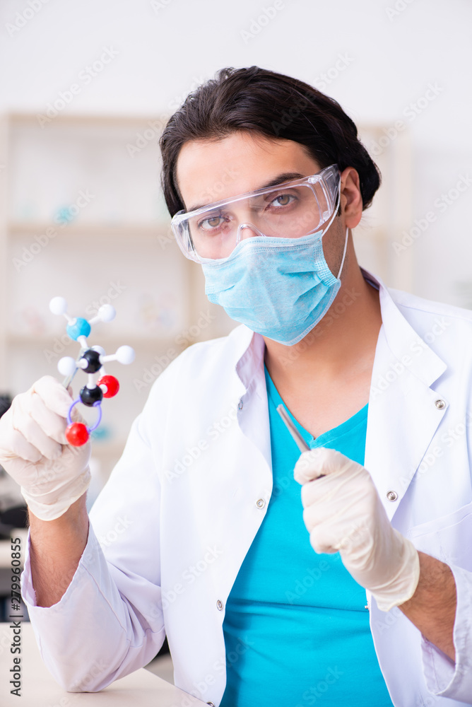 Fototapeta premium Young male chemist working in the lab