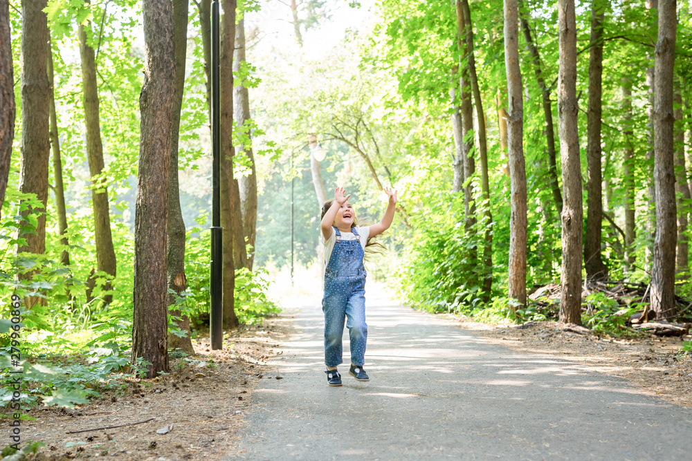 Children, childhood, people concept - little happy child girl walking in summer park Children, childhood, people concept - little happy child girl walking in summer park