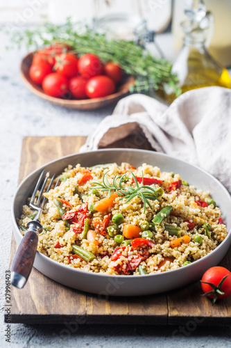Delicious homemade vegetarian cous cous with tomatoes, carrots, green bean, bell pepper and fresh basil photo