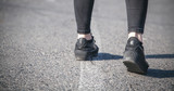 Woman with black stylish shoes in outdoor.