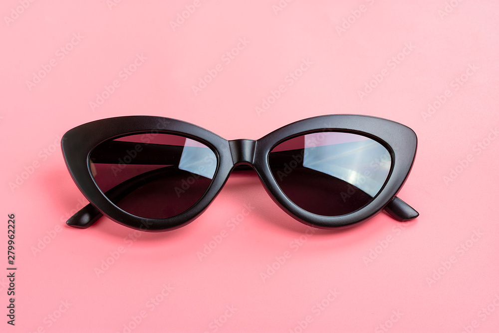 Stylish black sunglasses isolated on trendy pink background Flat lay Top view Summer, vacation, party, travel concept Stylish black sunglasses isolated on trendy pink background Flat lay Top view Summer, vacation, party, travel concept