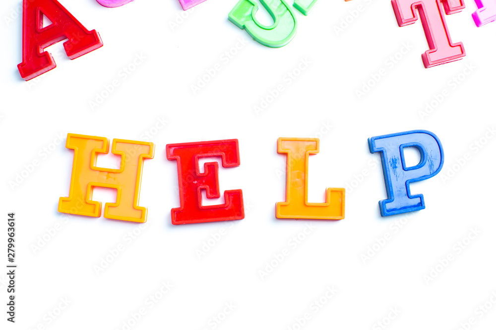 Heap of plastic colored alphabet letters close up. HELP Heap of plastic colored alphabet letters close up. HELP