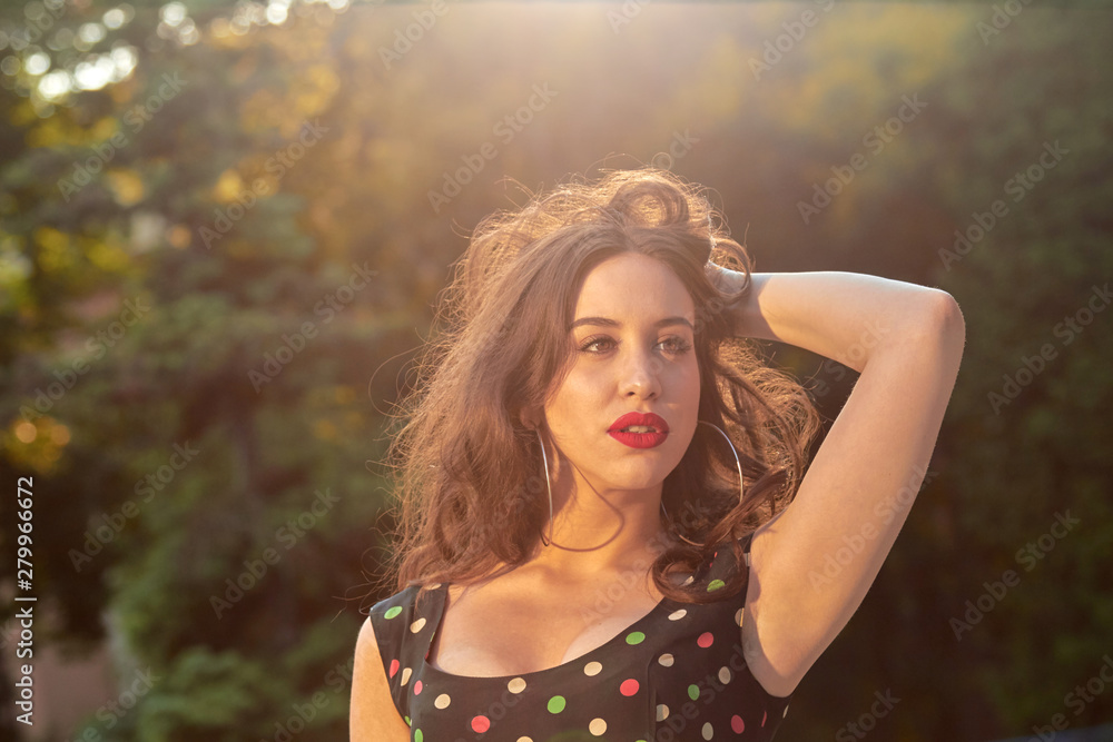 Fototapeta premium Elegant young woman posing in the park.