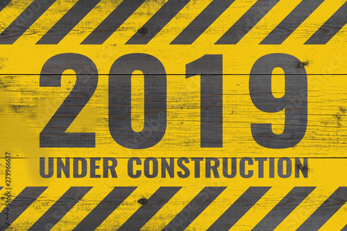 2019 under construction warning message painted on aged wooden planks