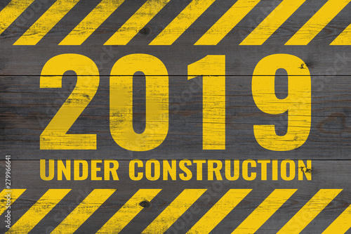 2019 under construction warning message painted on aged wooden planks