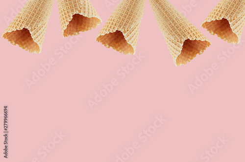 Empty waffle ice cream cones as decorative frame on pink background, mock up for advertising, design, menu.
