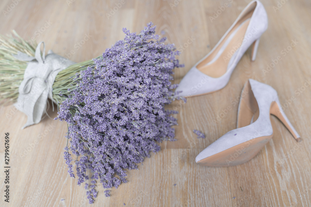 dry lavander bouquet and heel shoes tied with linen tape on wooden background top view. Flat lay. Wedding concept. dry lavander bouquet and heel shoes tied with linen tape on wooden background top view. Flat lay. Wedding concept.
