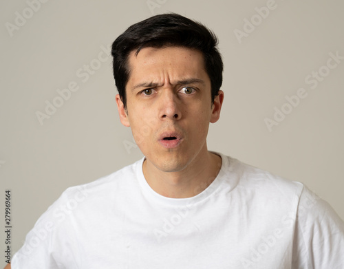 Human expressions and emotions. Young attractive man with a surprised face, eyes and mouth open.