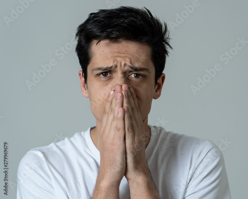 Portrait of sad and depressed man. Isolated on neutral background. Human expressions and emotions