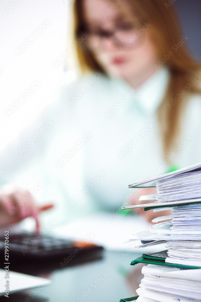 Bookkeeper or financial inspector making report, calculating or checking balance. Audit and tax service concept. Green colored image background