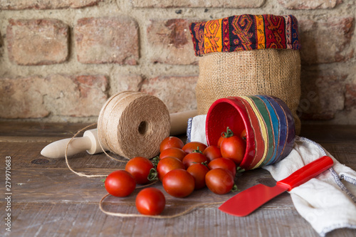 fresh tomatoes in the ceramic plate on the wooden background. photo