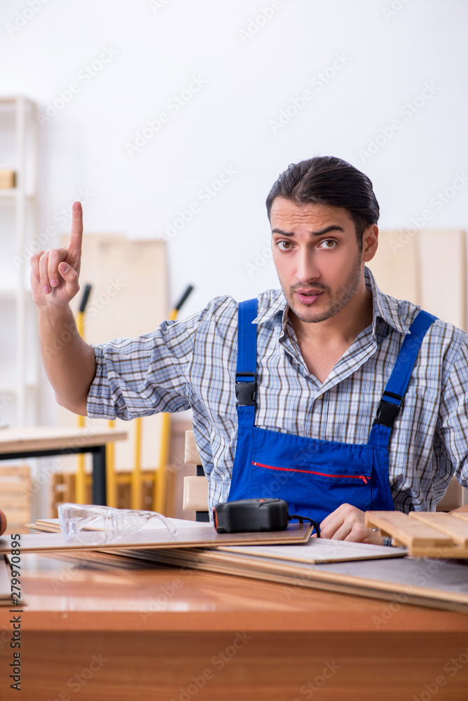 Young male carpenter working indoors Young male carpenter working indoors