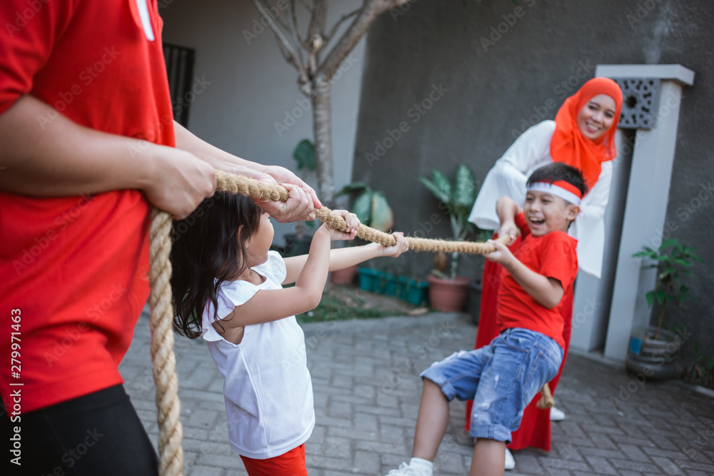 family tug of war during indonesia independence day celebration together