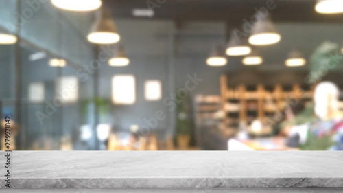 Empty white marble stone table top and blurred bokeh cafe and restaurent interior background with vintage filter - can used for display or montage your products.