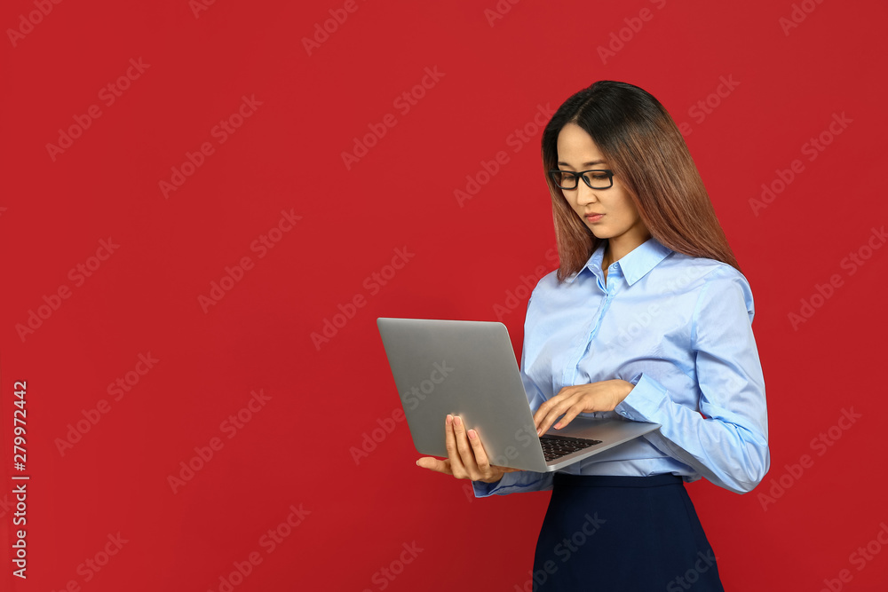Asian businesswoman with laptop on color background Asian businesswoman with laptop on color background