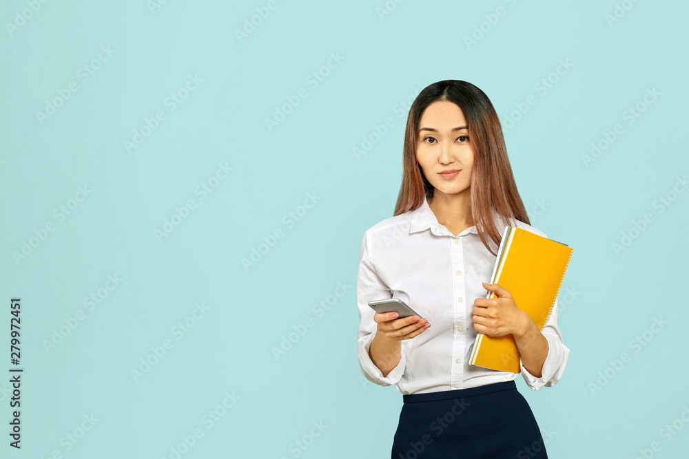 Asian businesswoman with mobile phone on color background Asian businesswoman with mobile phone on color background