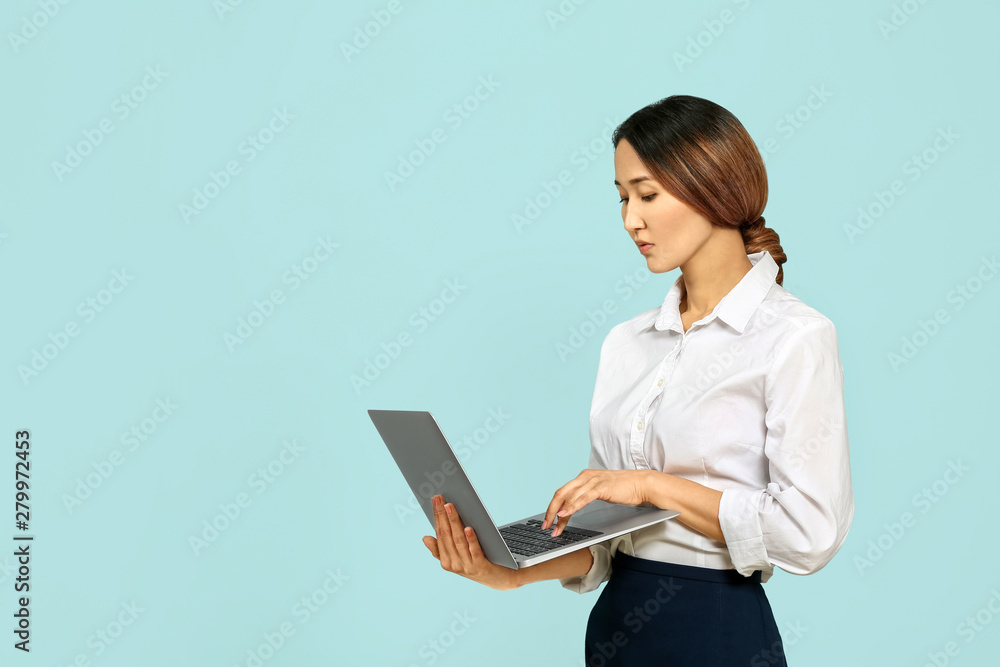 Asian businesswoman with laptop on color background Asian businesswoman with laptop on color background